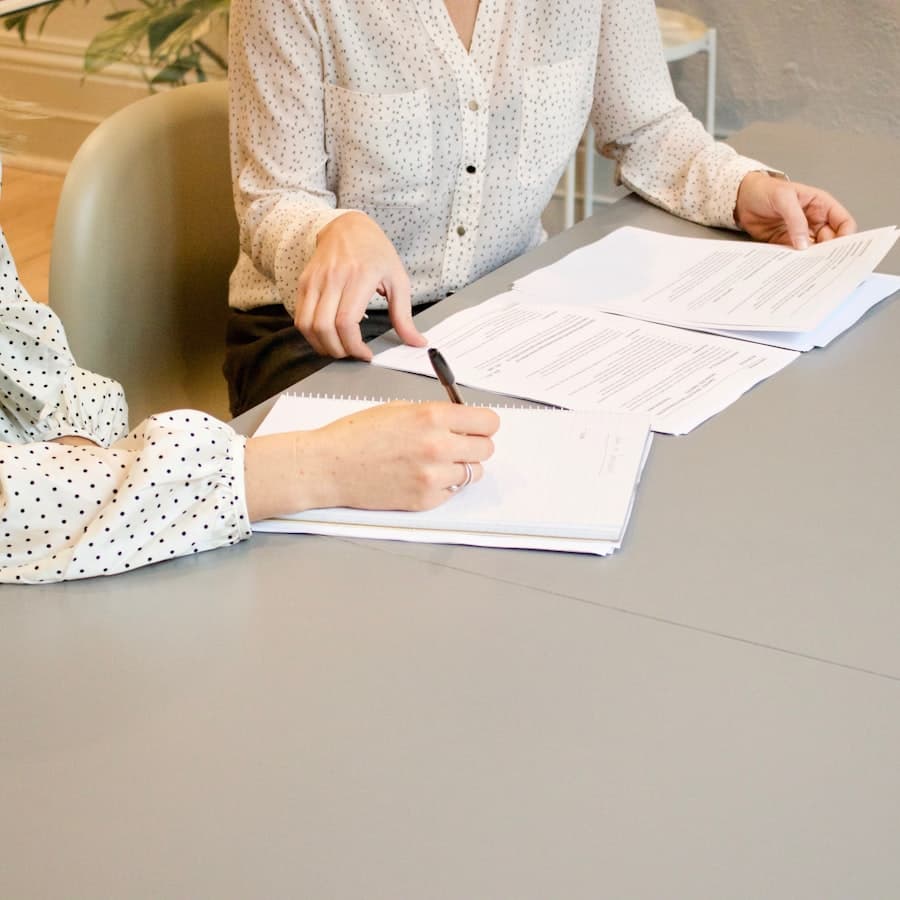 An advisor and client reviewing financial documents together
